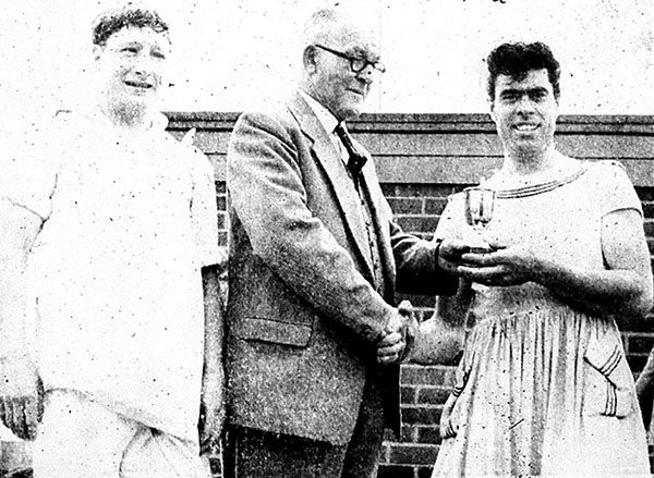 Pat Smith and Edward Shaw receive the trophy from F T J Hudson.
